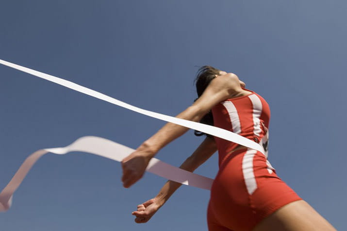 female-runner-crossing-the-finish-line